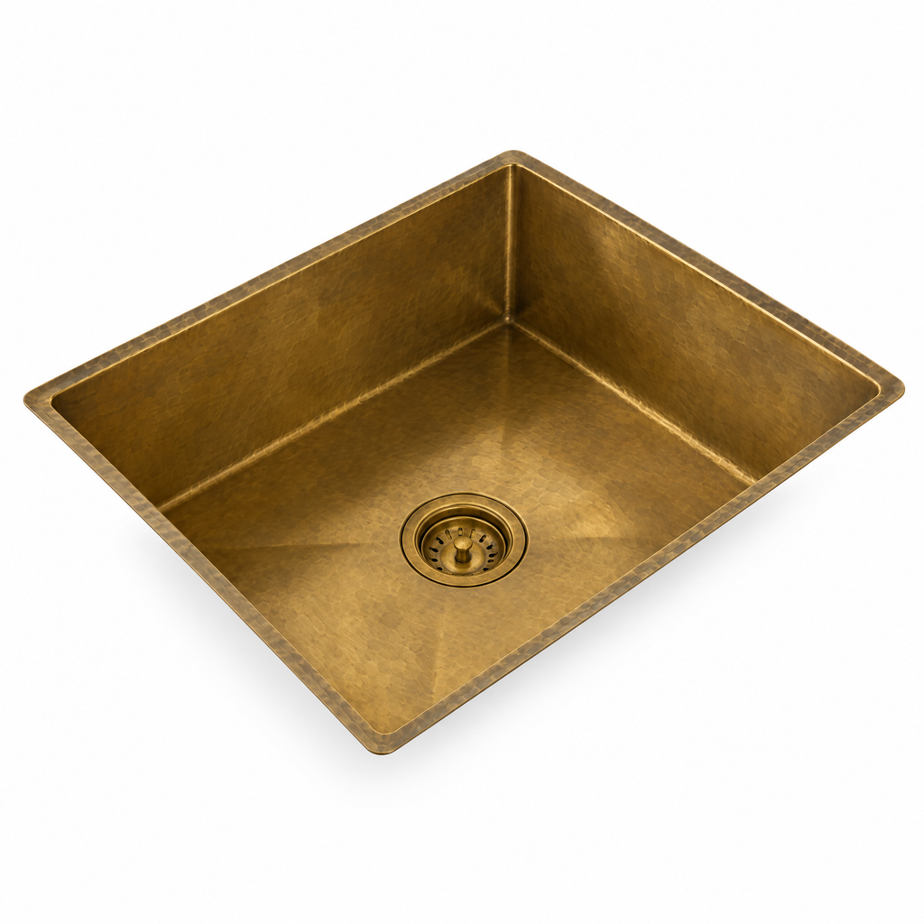 Handmade rectangular brass sink on white background