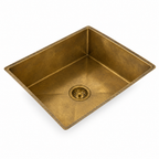 Handmade rectangular brass sink on white background