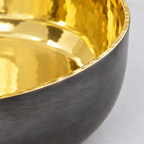 Close-up of the polished hammered brass interior against the dark bronze exterior