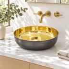Oil-rubbed bronze and brass round vessel sink on a sunlit white marble vanity