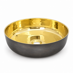 Round vessel sink with polished brass interior and oil-rubbed bronze exterior on white