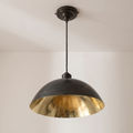 Oiled black brass dome pendant with hammered brass interior and black cord, light background