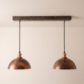 Oxidized copper dome pendant light set with linear canopy bar