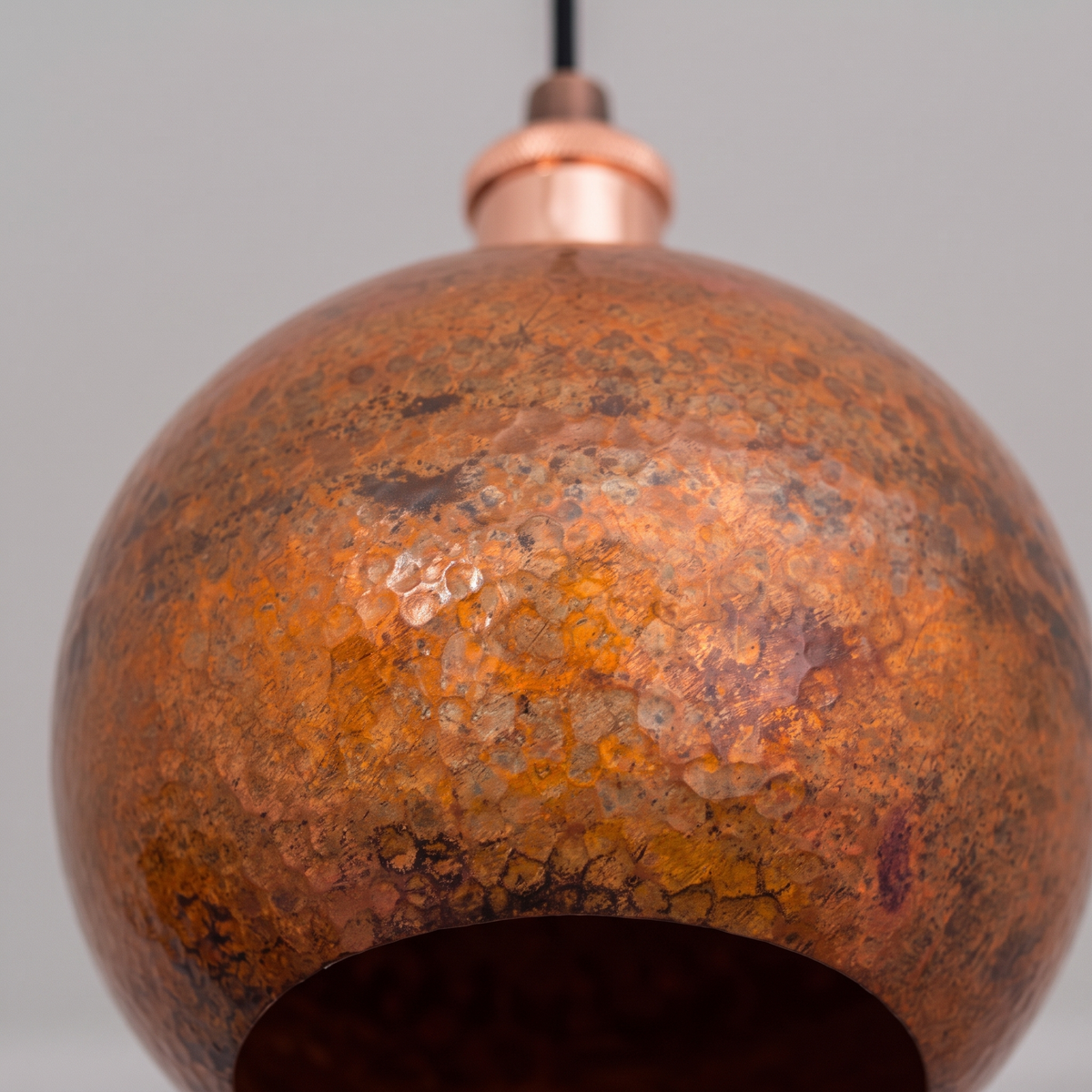 Close-up of the lightly hammered, mottled oxidized copper globe