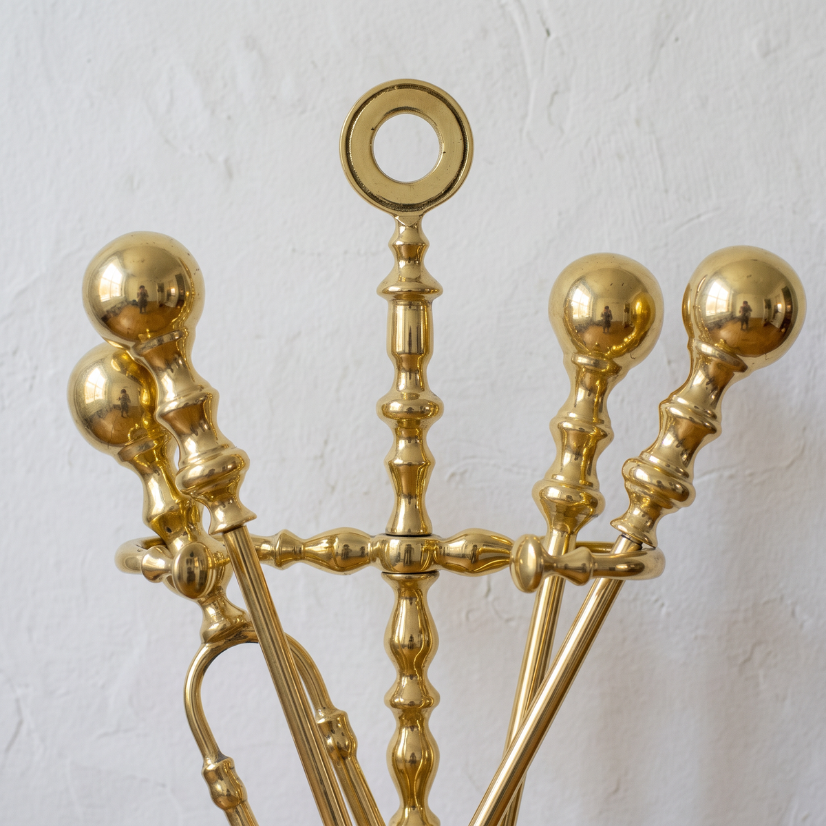 Close-up of the ring handle and round ball-knob tool handles in polished brass