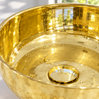 Round Brass Countertop Vessel Sink, close-up of the rolled rim and raised drain flange