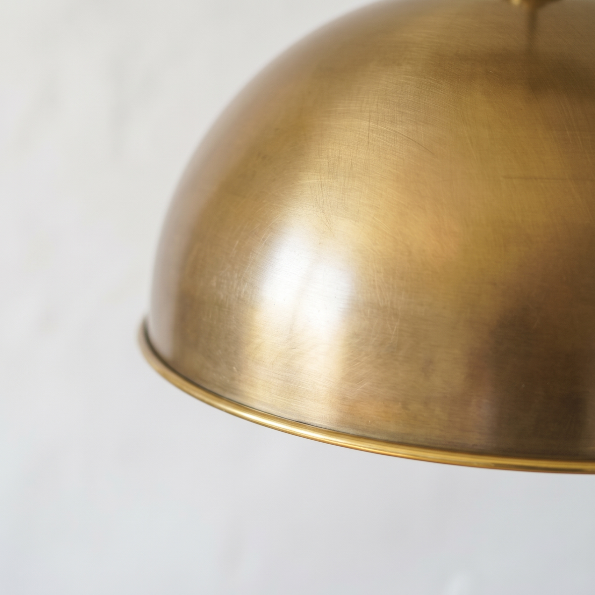 Close-up of the smooth aged brass finish and rolled rim