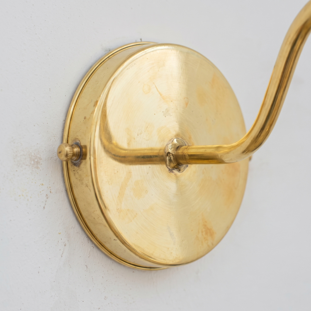 Close-up of the unlacquered brass round backplate and arm