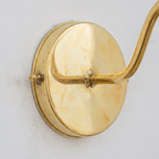 Close-up of the unlacquered brass round backplate and arm